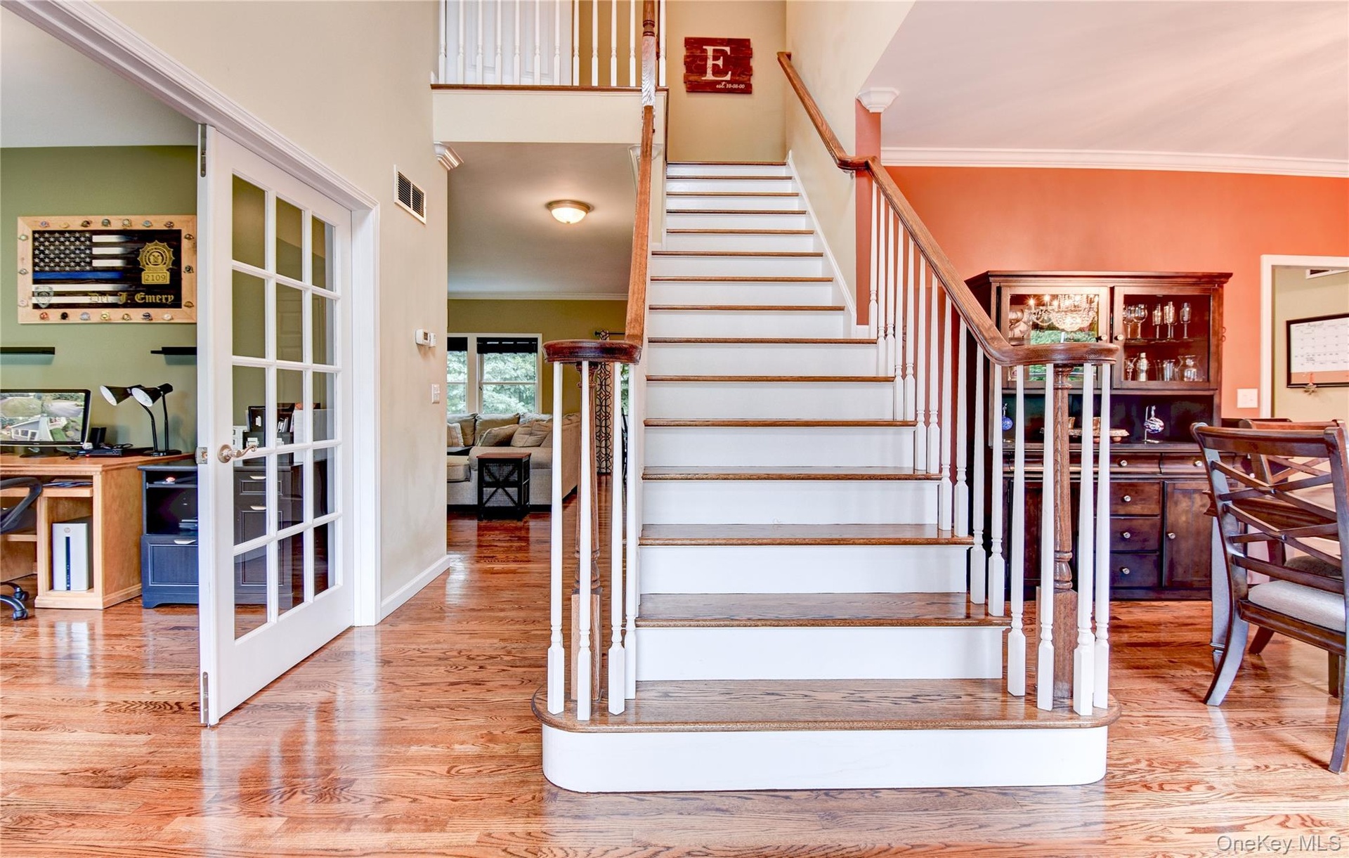 Grand staircase featuring wood treads and white risers