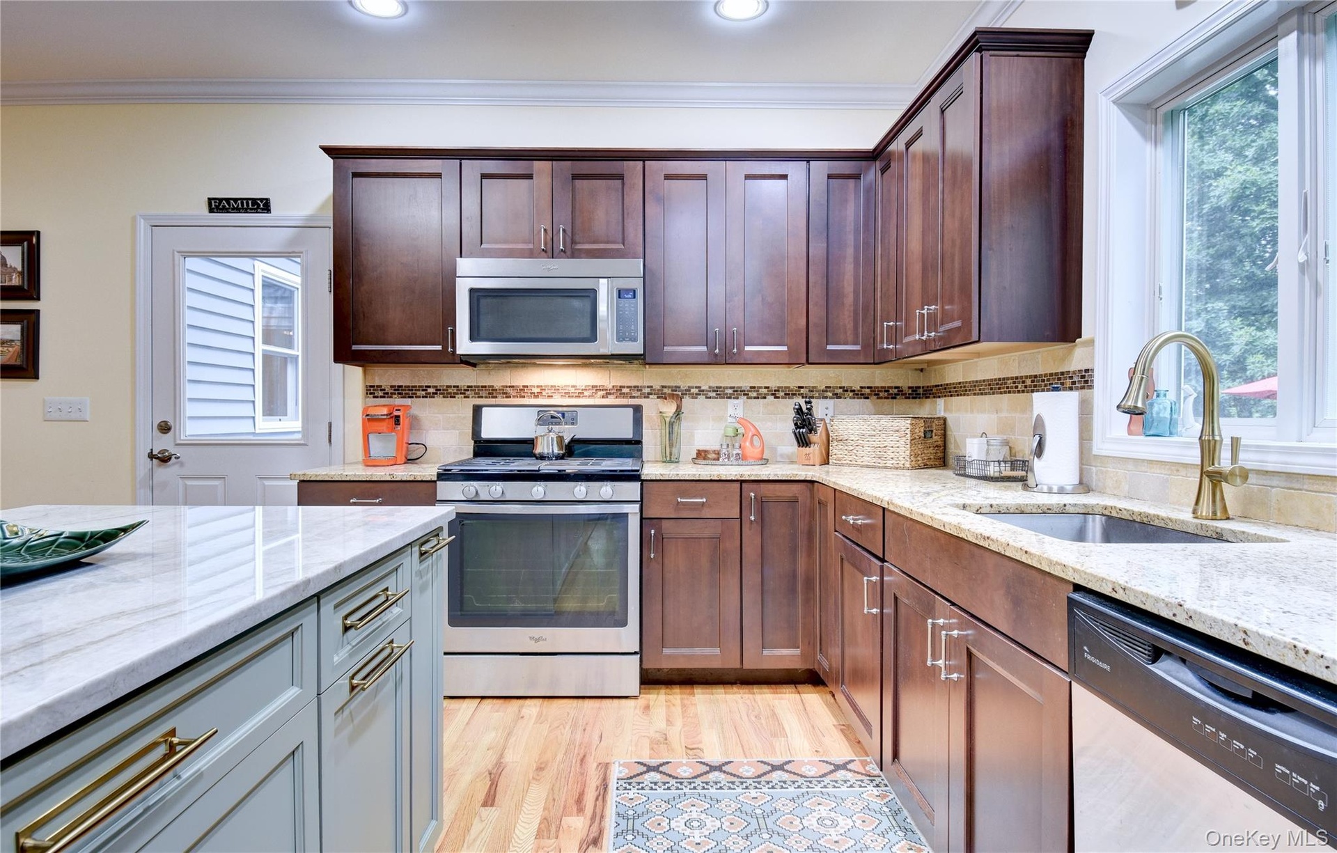 Legal accessory apartment: Kitchen featuring wood flooring, dark wood cabinetry