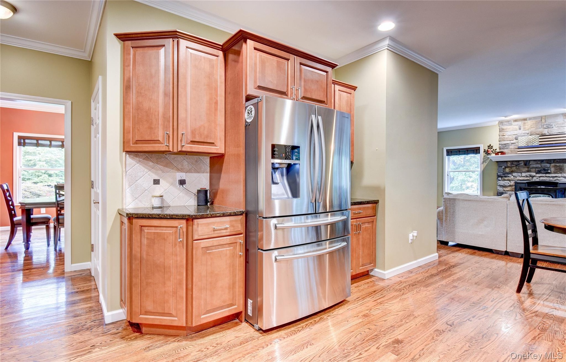 Stainless steel French door refrigerator, wood flooring,  granite counters and crown molding