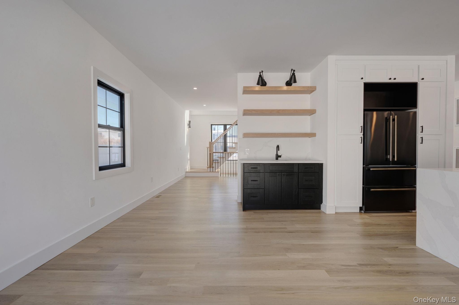right dining space positioned beside kitchen and living room featuring wet bar and large glass sliders, offering great natural light and easy access t