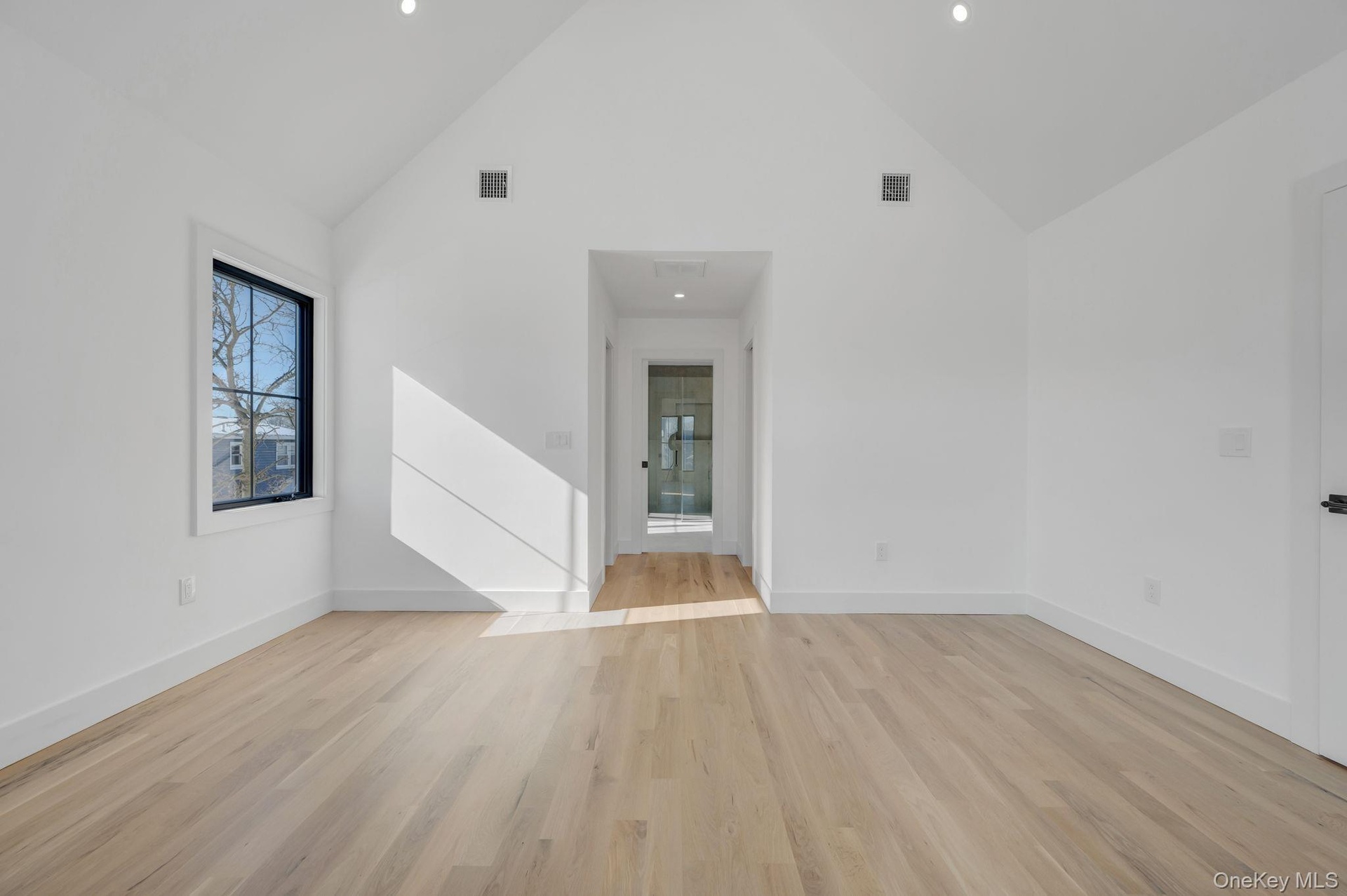 Spacious retreat with vaulted ceilings and large windows, dual walk in closets and primary bath.