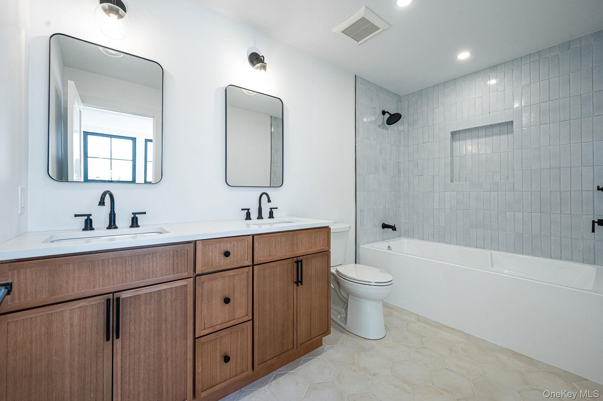 Full hall bath serving the secondary bedrooms, designed with modern finishes and functionality in mind.