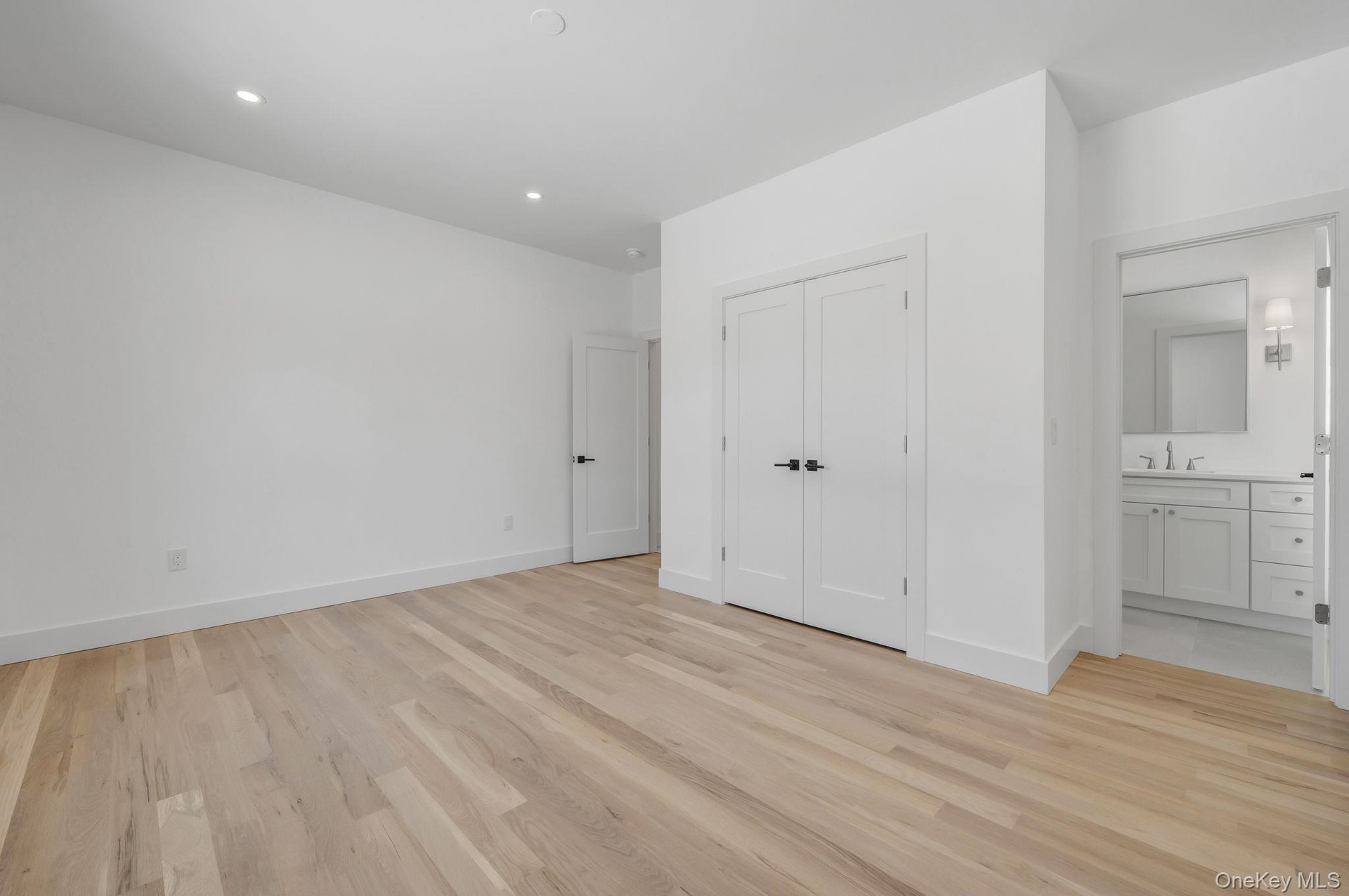 Private first floor junior primary bedroom with a full bath, ideal for guests, or a flexible office setup.