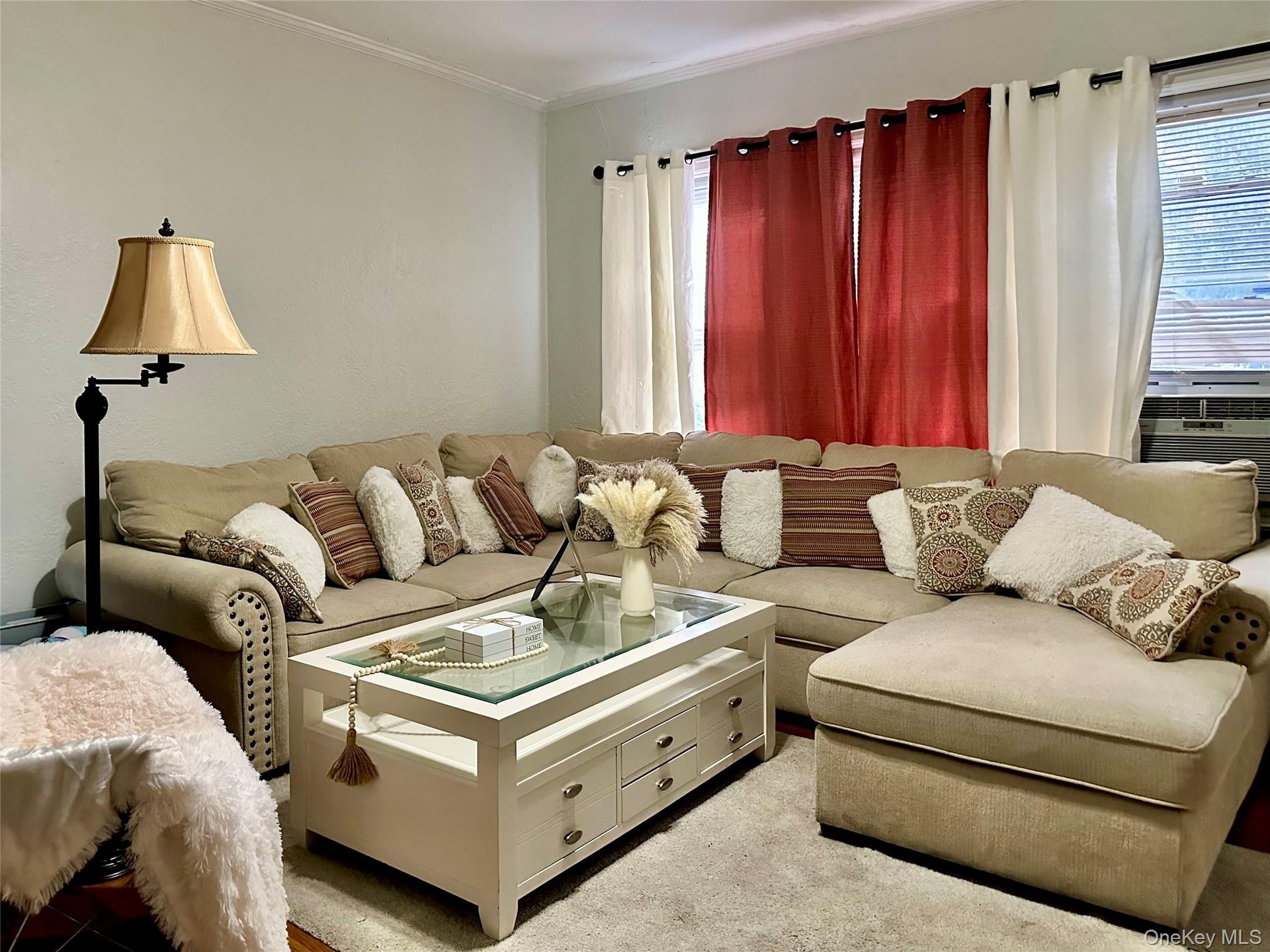 Living room with ornamental molding and cooling unit