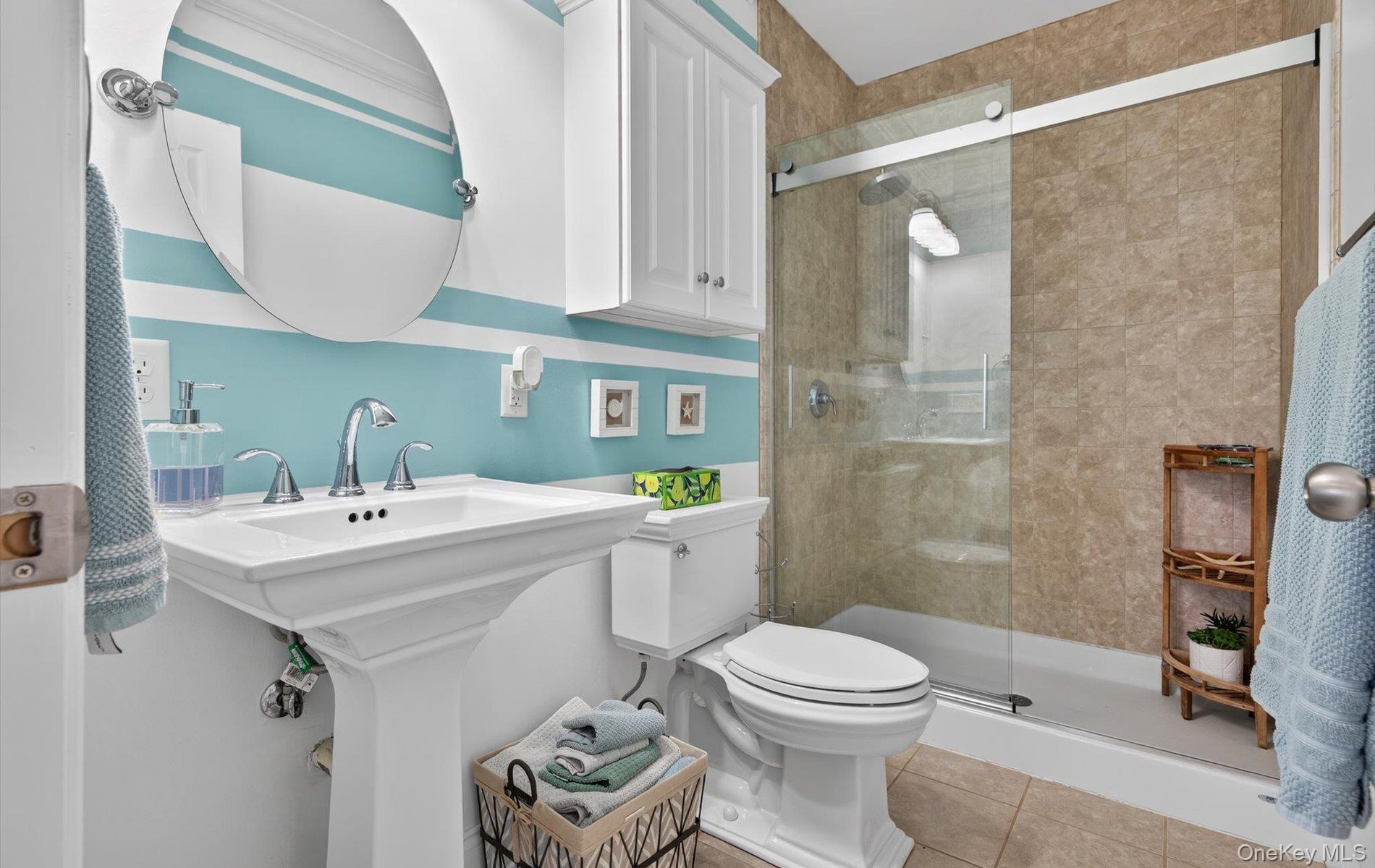 Full bathroom with a stall shower and light tile patterned floors