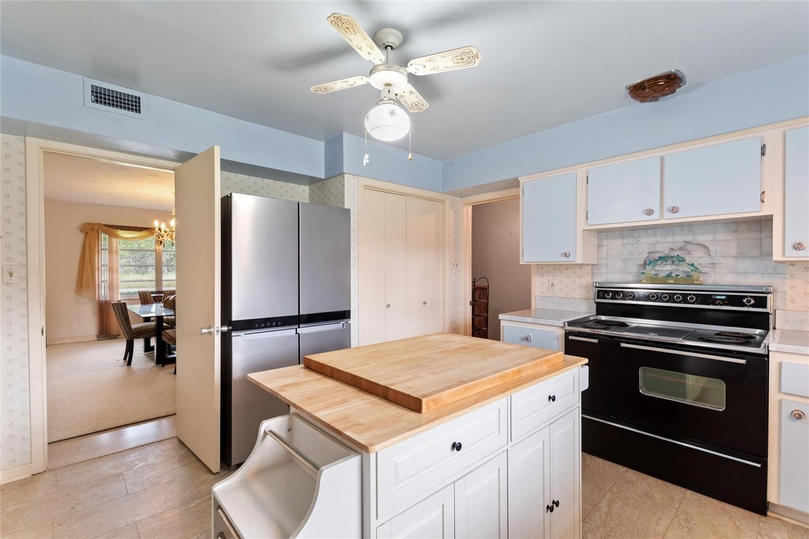 Kitchen with view into formal dining room.  There are two pantry closets