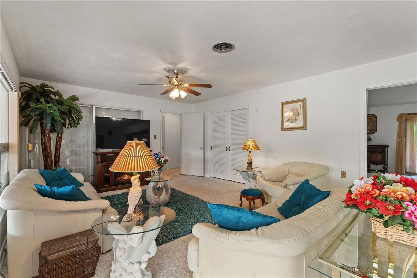View of family room.  The double doors in the back right is a storage closet.  This home has LOTS OF STORAGE!