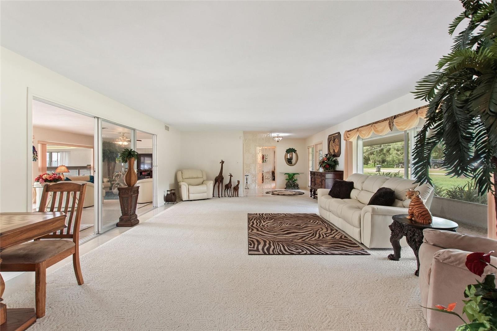 View looking back from the dining area to the living room, foyer.  To the left are the informal living areas.