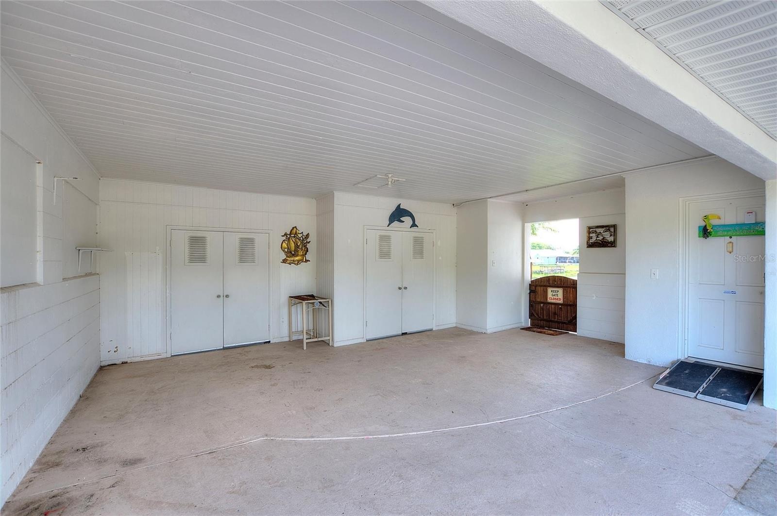 Enclosed carport/garage area.  The doors in the back are to storage areas.