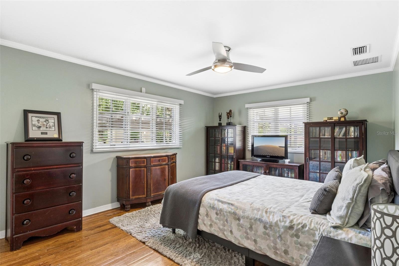 Bedroom #3 featuring customed closet and natural wood floors.