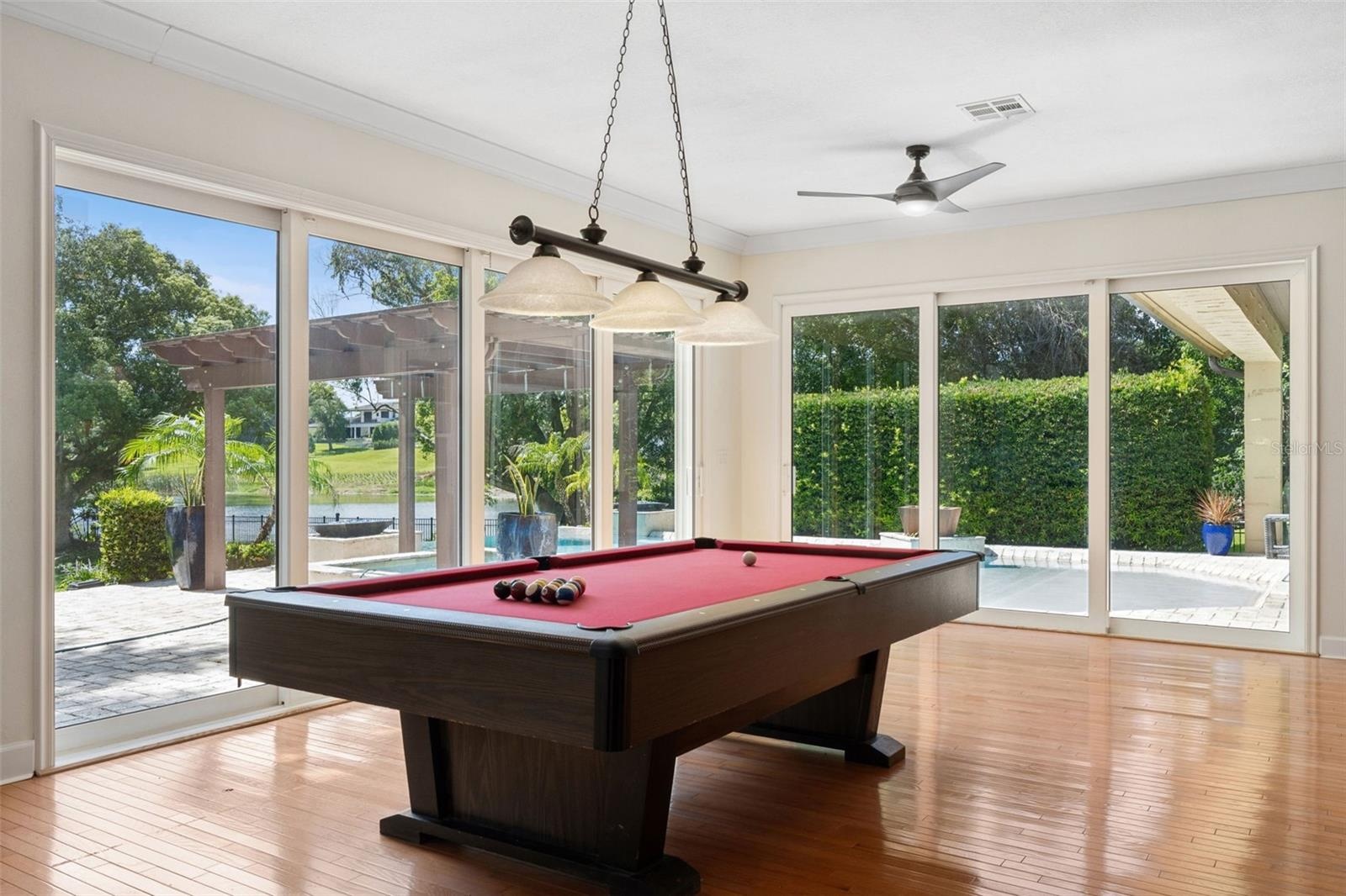 Game area of the GREAT ROOM.  Large Sliding doors to open up the fresh air and always the view of the Lake and natural light