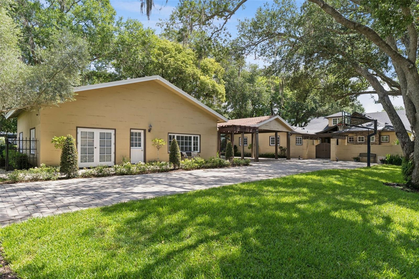 Guest house, Porte Cochere and Main Home.  Long paver driveway