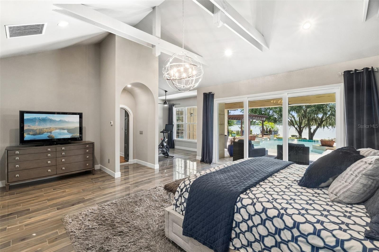 Spacious Primary Bdroom  with Flex room, vaulted ceilings with beams and of course a view of the Lake and the Pool!!!!