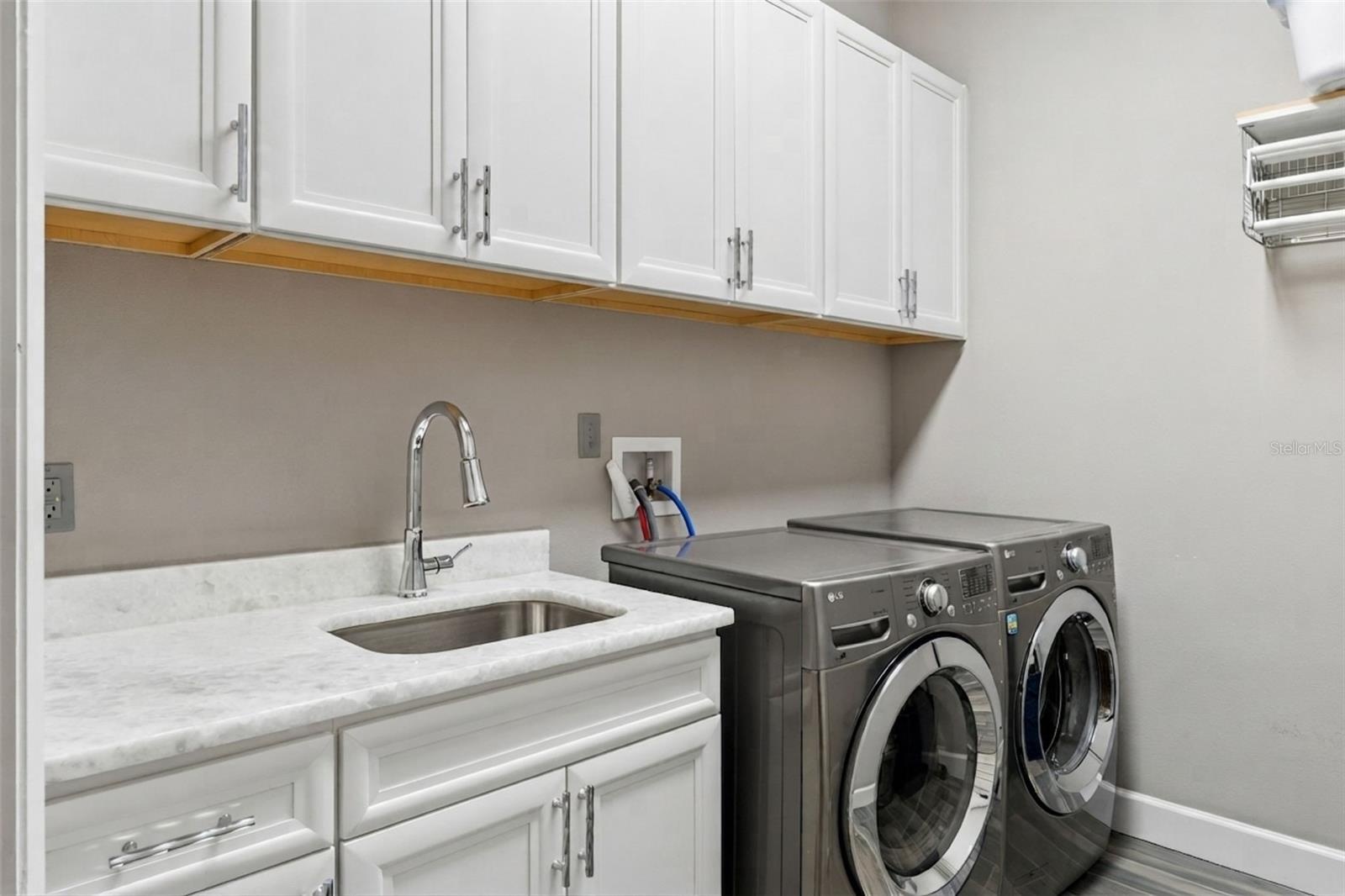 Private Laundry in Primary Suite.  Complete with Sink, Cabinets and Drying Racks
