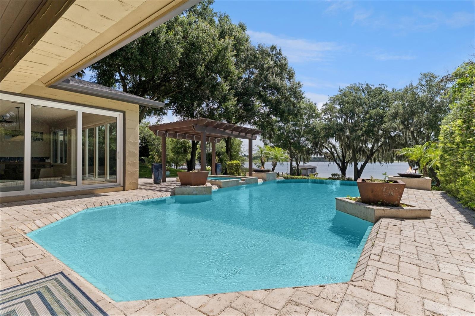 Infinity Pool and Spa.     Decorative planters and two natural gas fed fire pit features complete the luxury pool experience