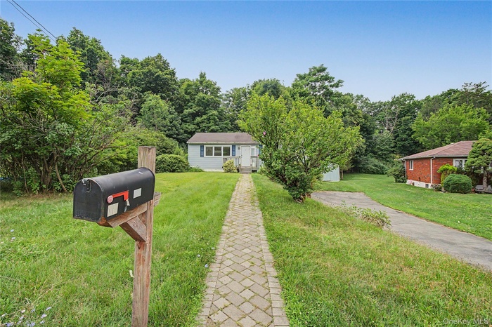 Spacious front yard with a long private driveway and peaceful surroundings.