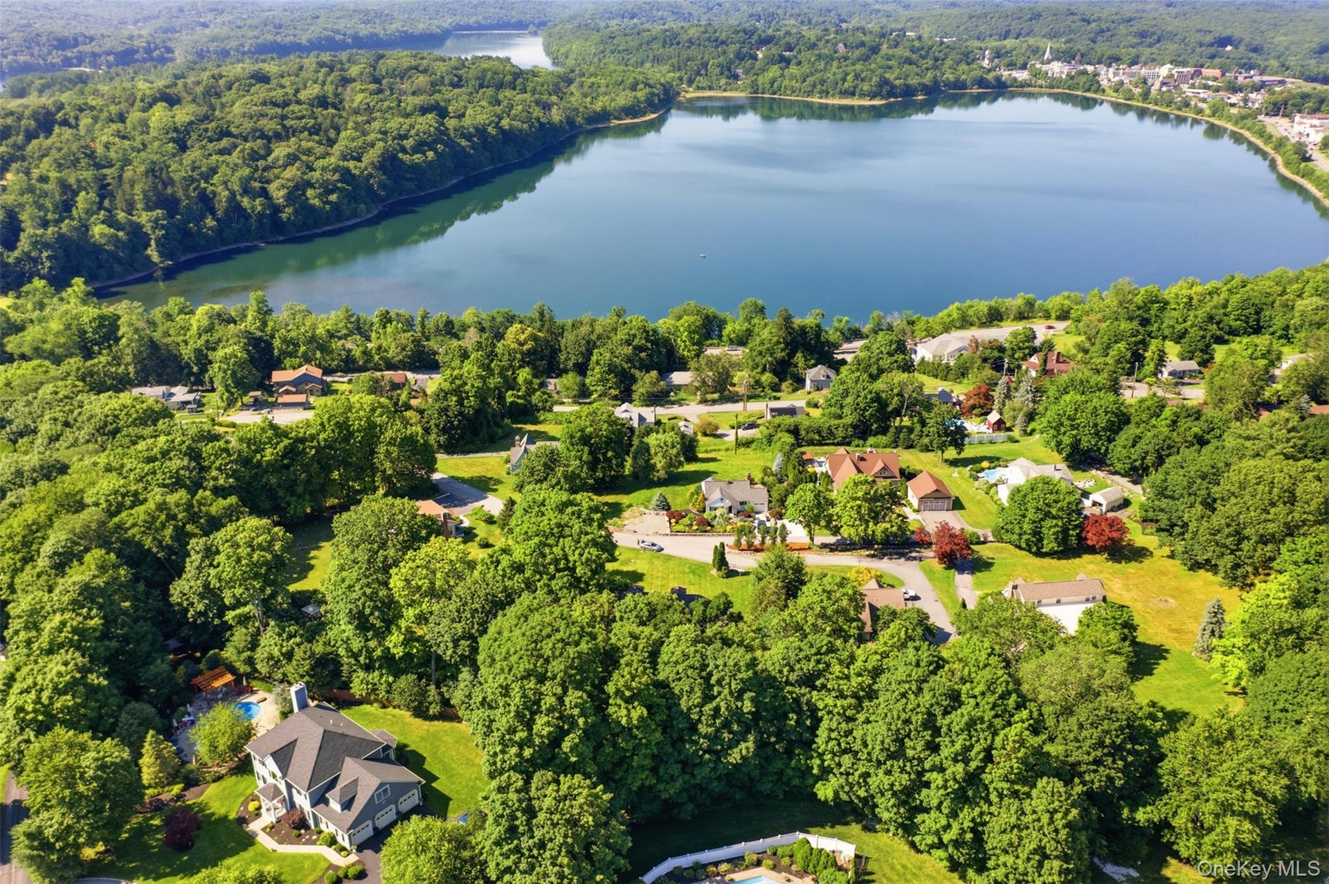 Elevated aerial perspective showcasing a residential area with a prominent body of water