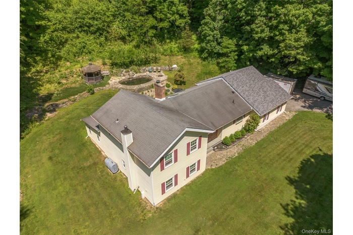 Beautiful home on over 2 acres with a stunning backyard manmade pond and flexible layout