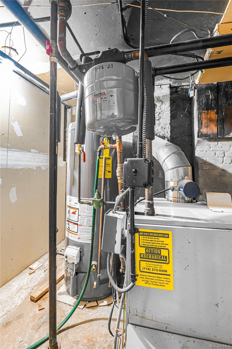 Mechanical room featuring a water heater, expansion tank, and furnace