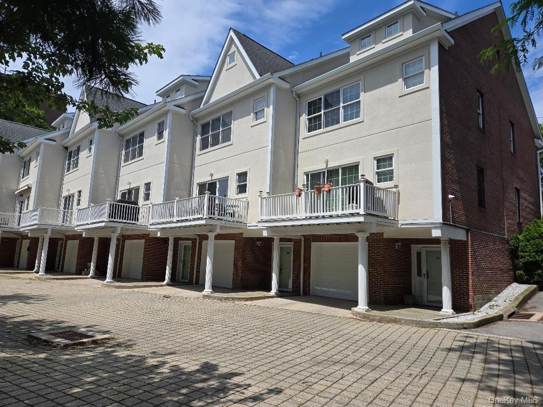 Rear of the units, showing all 4 floors of living, including the update decking and garages.