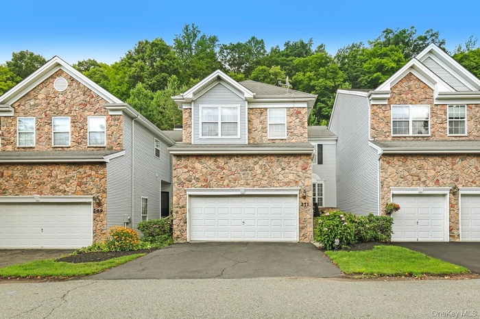 Multi-story townhome with a stone and siding exterior