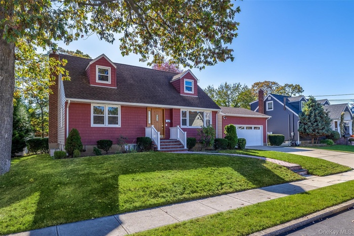 Rear dormered Cape with two car detached garage