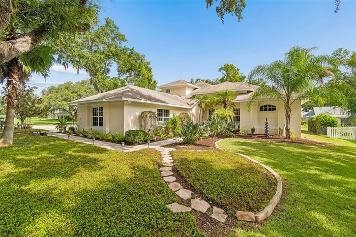 The front yard provides entertainment watching all of the beautiful birds in the majestic trees from your front porch.