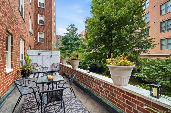 Begin your tour with the home's showstopping feature: a spectacular private terrace - only one of two in the building!