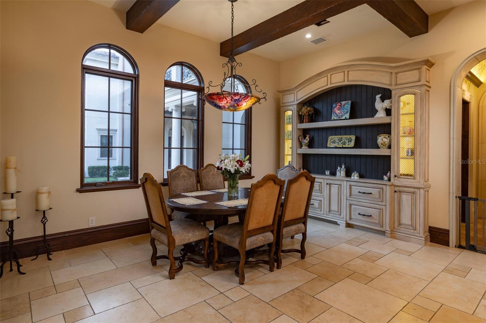 eat in kitchen nook with inset built in details and beamed ceilings