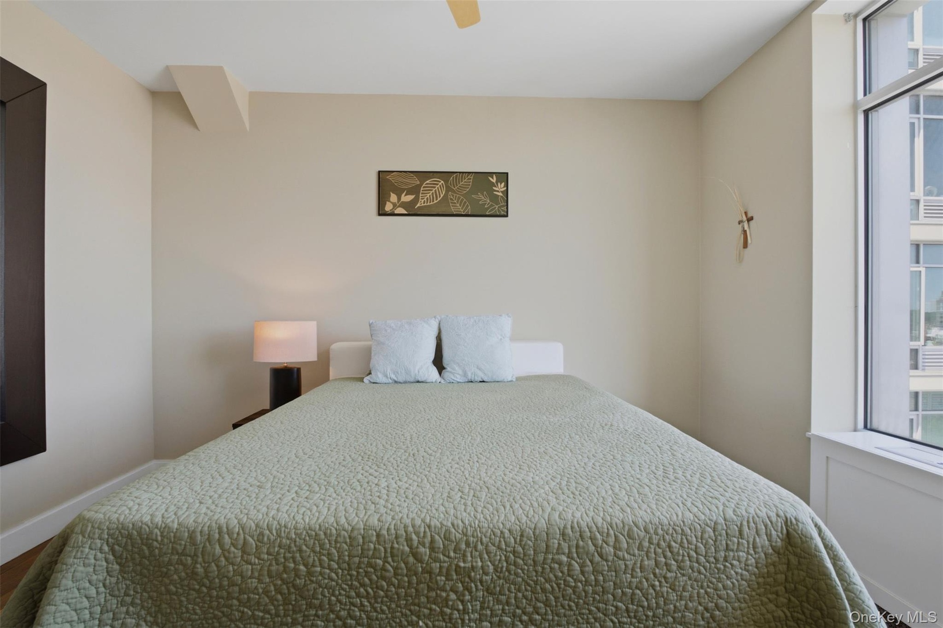 Bedroom 3 featuring an expansive window, a built-in window ledge, and light-toned walls