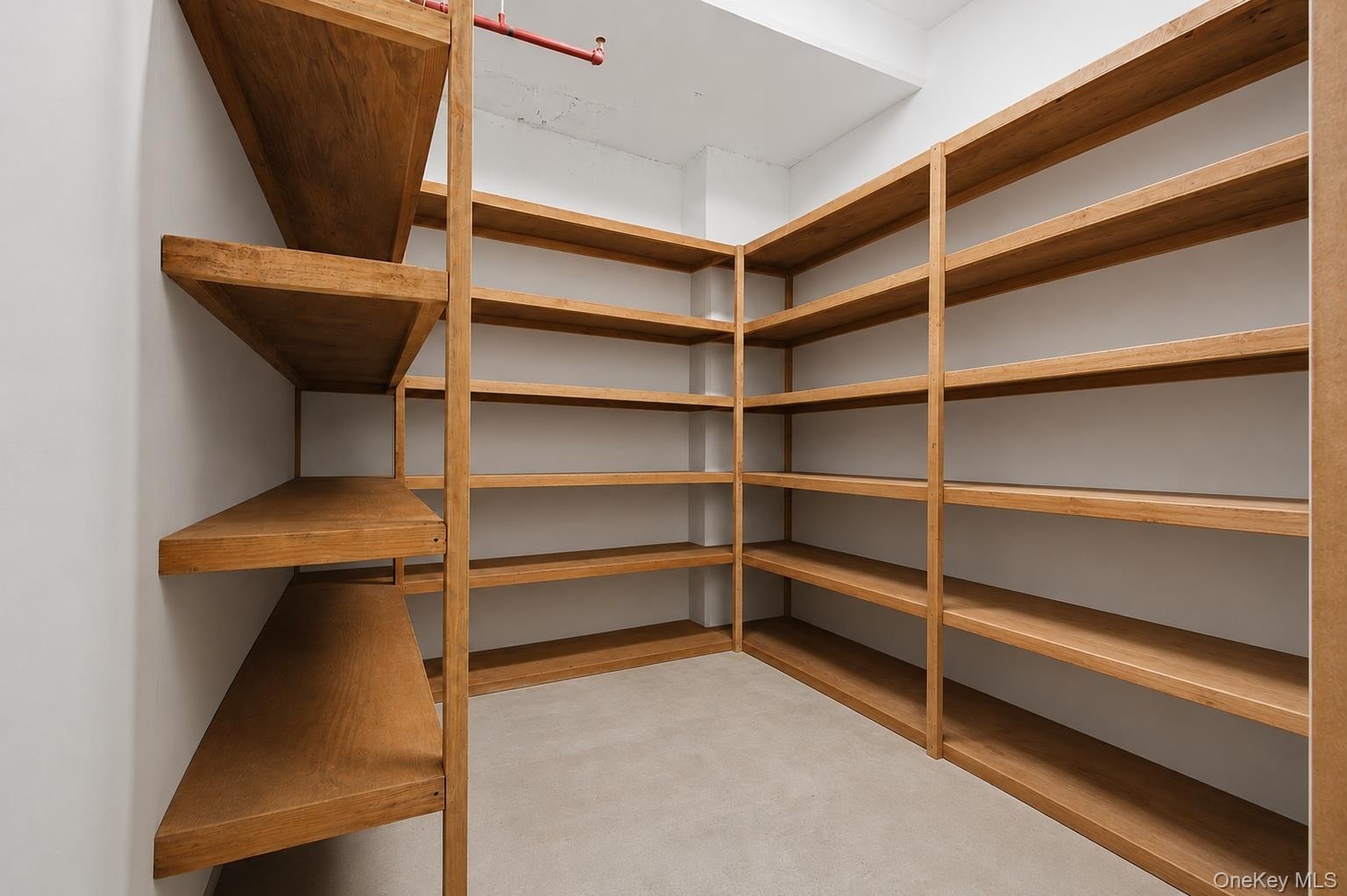 Custom shelving system with wood-finish construction providing extensive storage