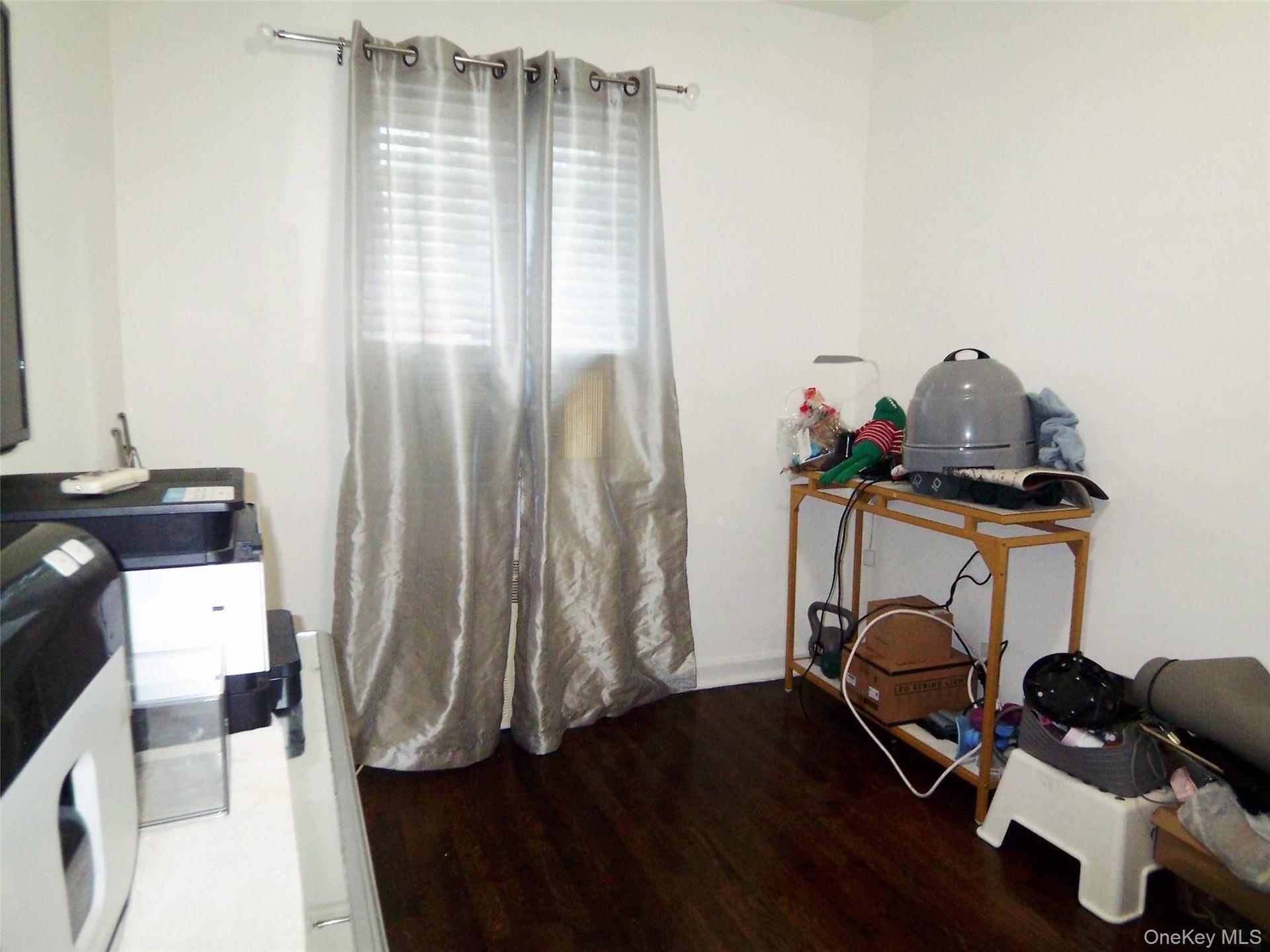 Crisp white walls complement dark wood-finish flooring