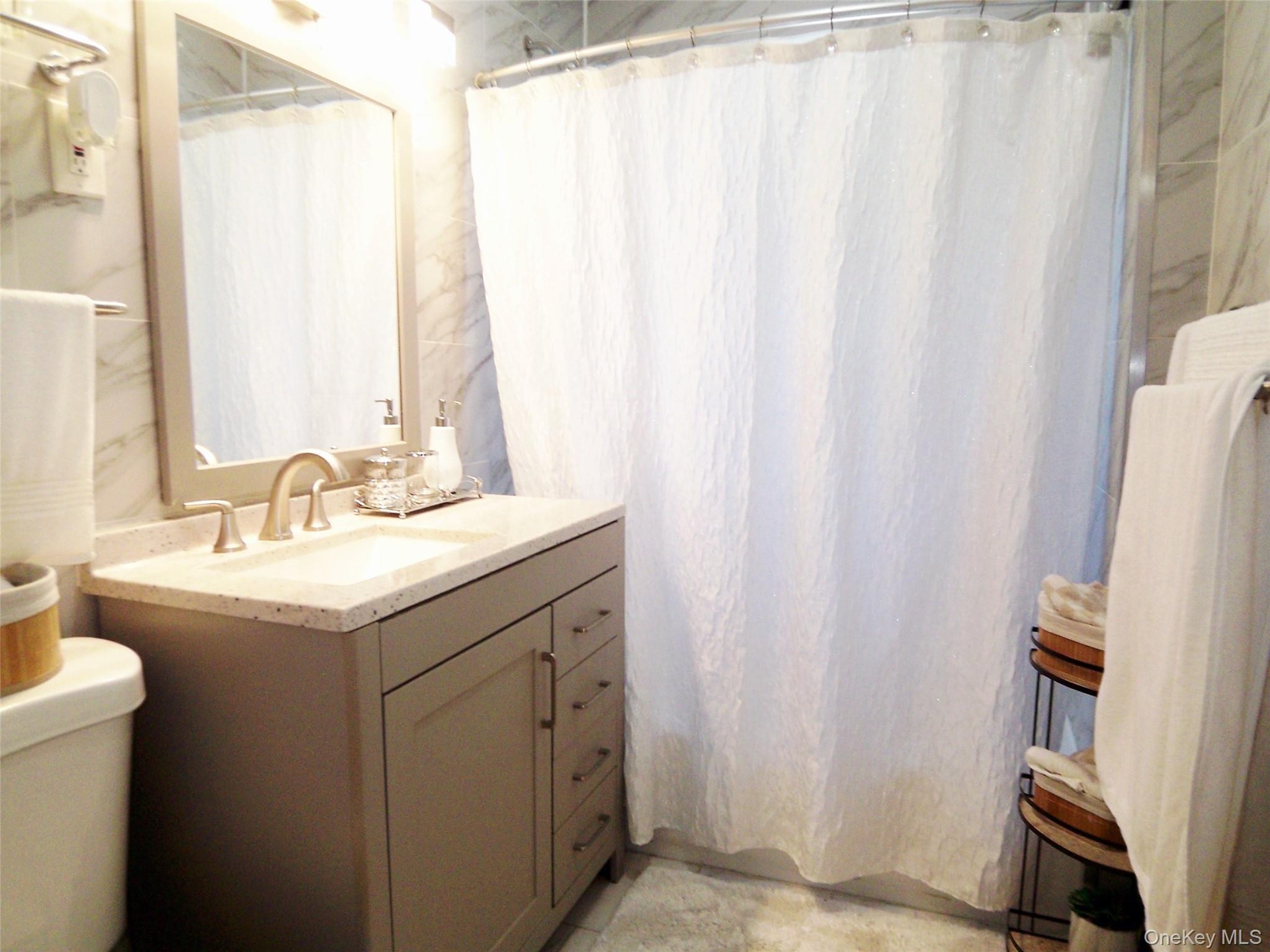 Contemporary vanity with a neutral-toned base, integrated sink, and light-toned countertop