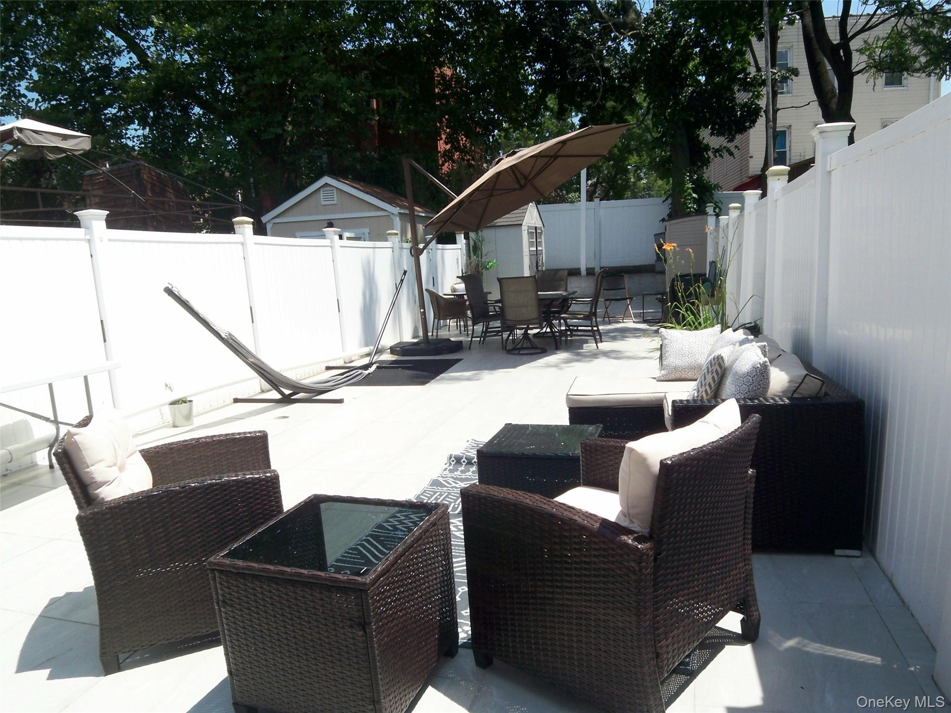 Expansive paved patio with privacy fencing