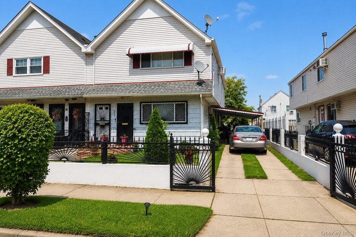 Property exterior featuring white siding and a covered driveway