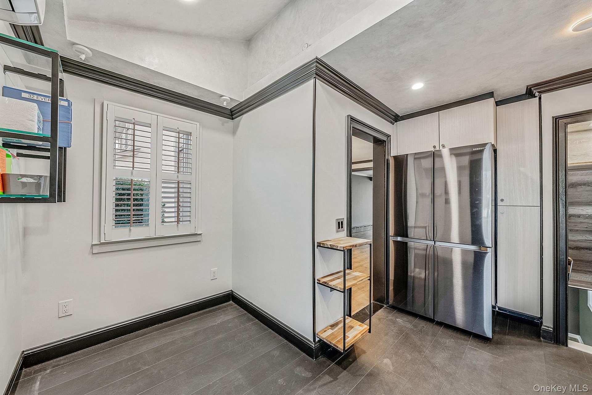 Empty room with ornamental molding and recessed lighting