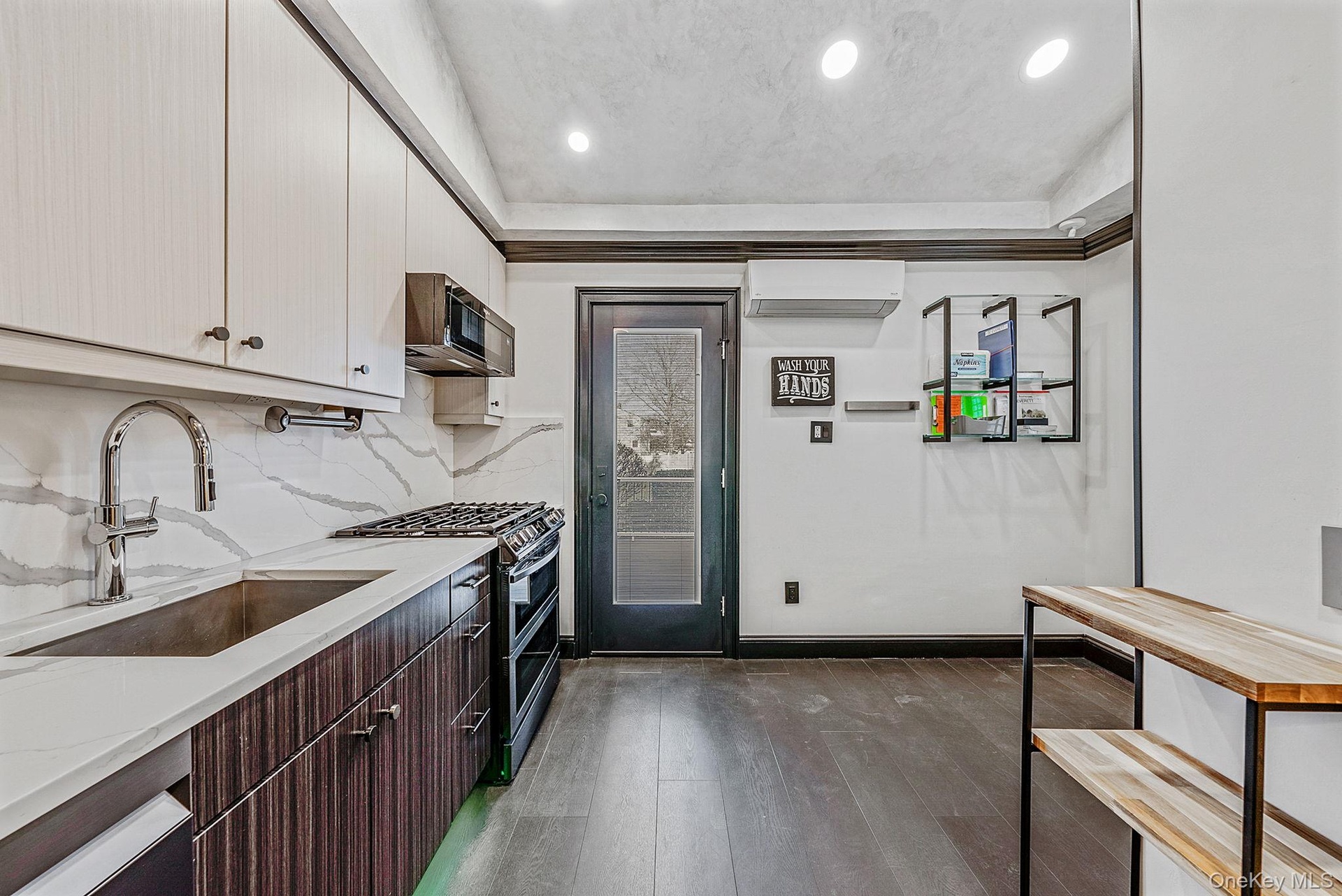 Kitchen with double oven range, dark brown cabinets, modern cabinets, dark wood-style floors, and recessed lighting