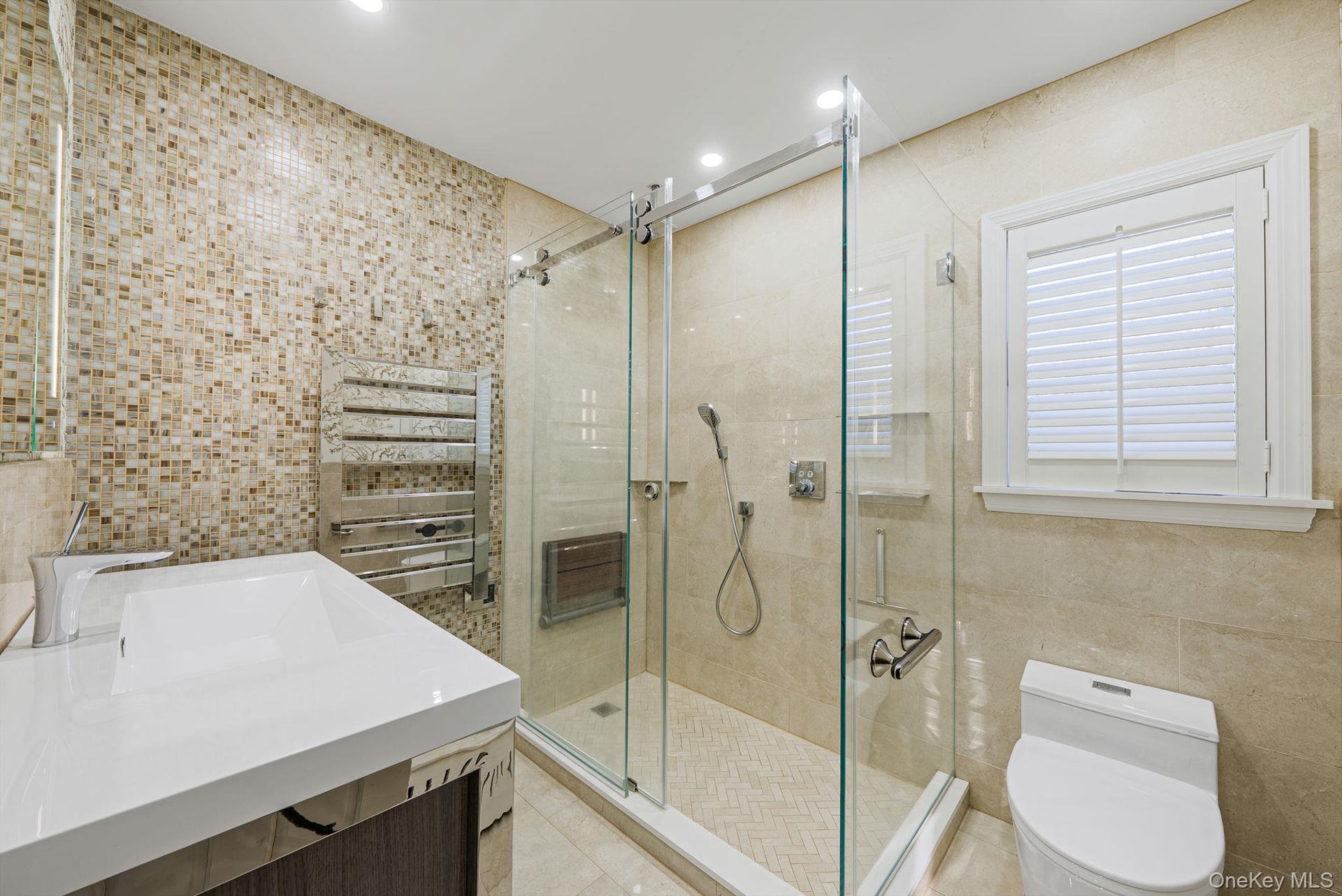 Bathroom with tile walls, vanity, a stall shower, recessed lighting, and light tile patterned flooring