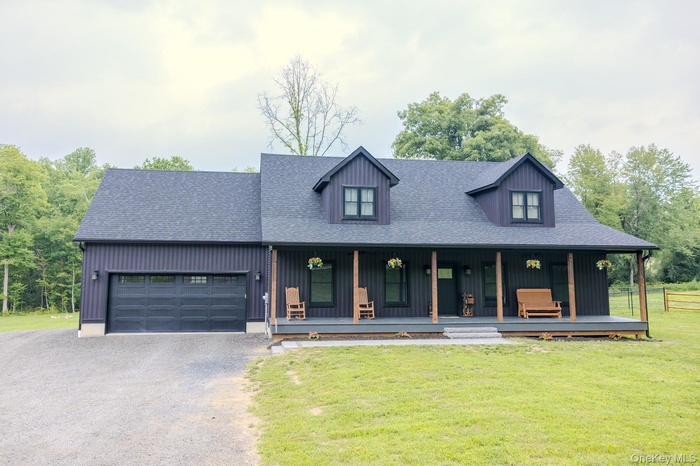 A full-length covered front porch creates a warm first impression, offering multiple places to relax, gather and enjoy the peaceful setting before you