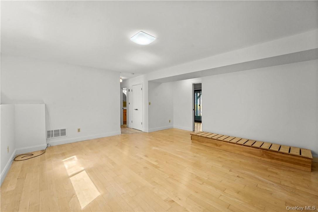 View of the family room.  Laundry closet is in the center and full bath beyond that.  Office is on the right.