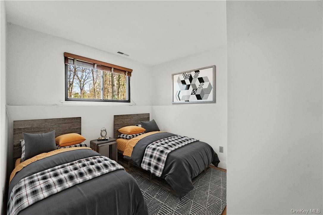 Lower level virtually staged bedroom.  The closet is in the right.