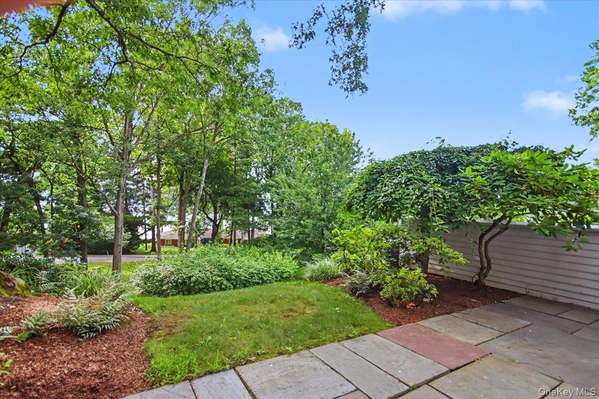 Primary and guest bedrooms lead to private back stone patio.