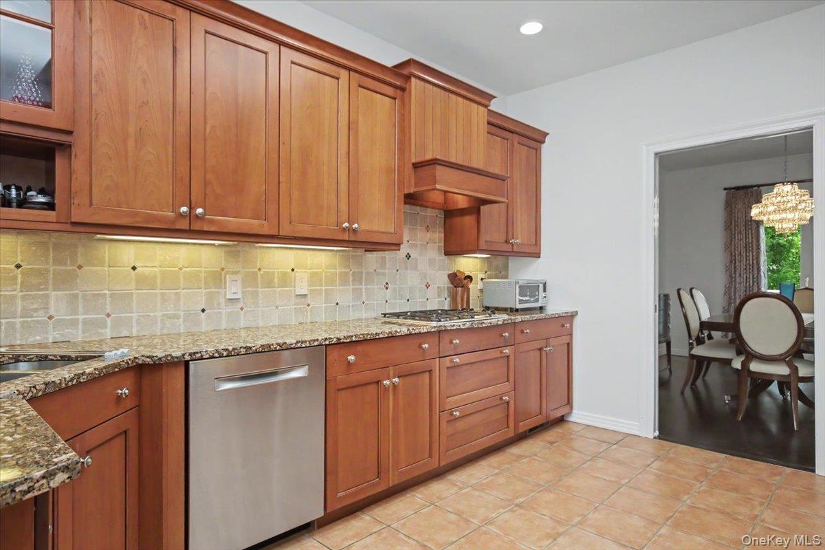 Granite counters, wood cabinets, ceramic tiled floor.