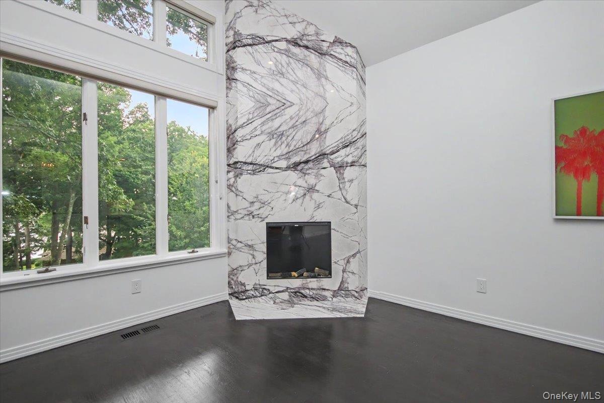 The newly installed marble fireplace surround is a piece of art. Natural light is abundant!