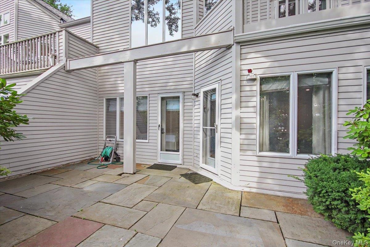 Primary and guest bedrooms lead to private stone patio.