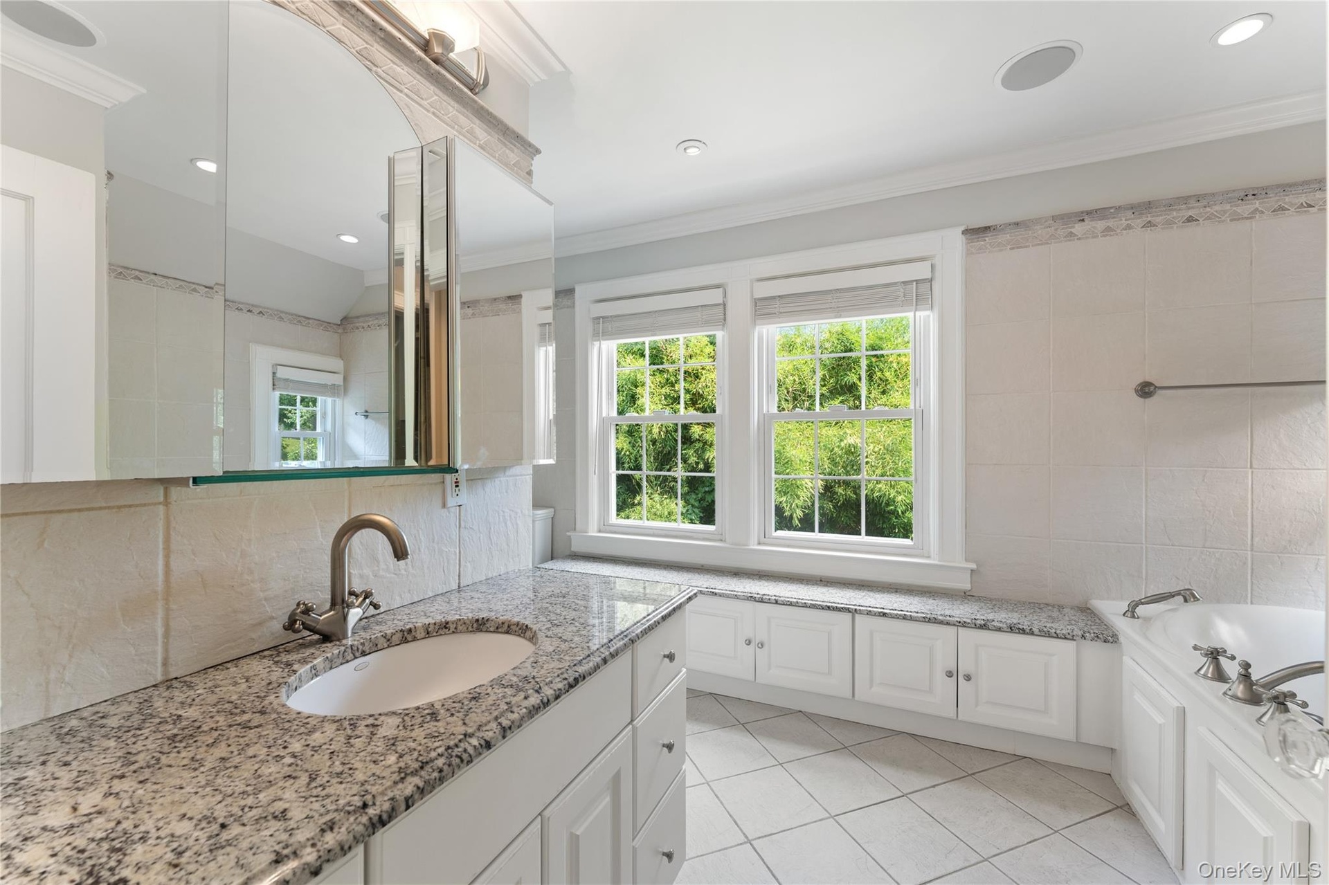 Primary Bathroom with built-in cabinetry and soaking tub.