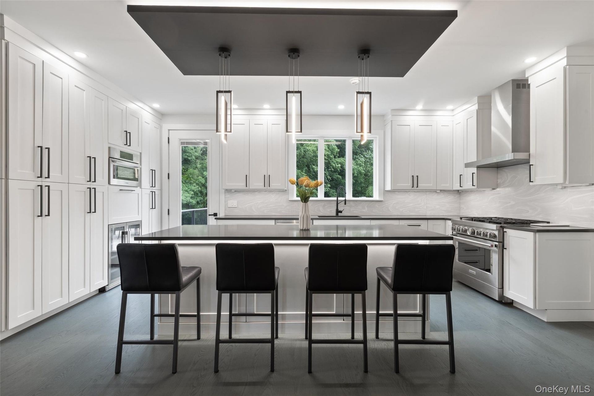 Kitchen with Quartz countertops, stainless steel appliances, wine fridge, and walk-in pantry