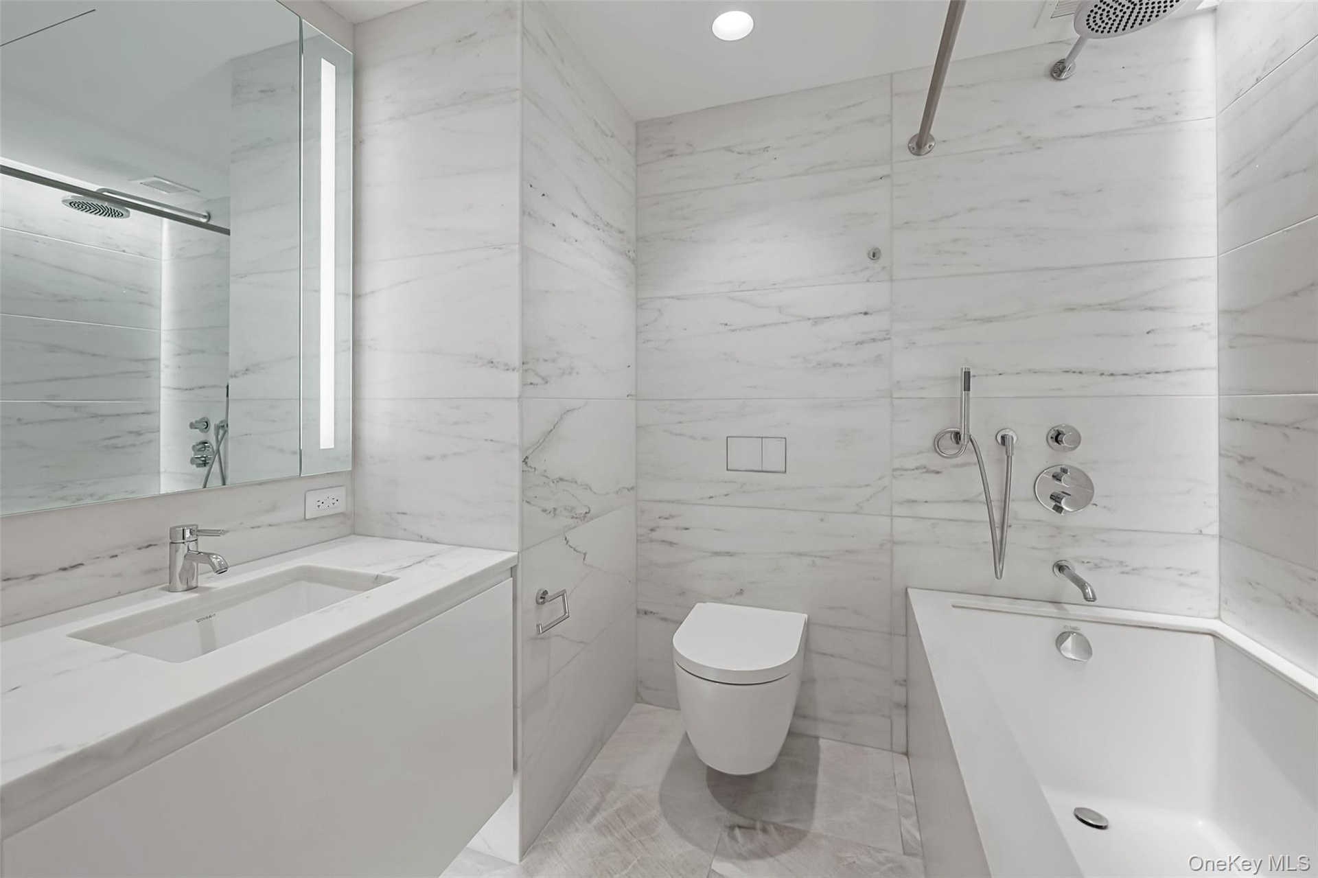 Secondary Bedroom Ensuite bathroom.  Spa-inspired bathrooms feature Blue de Savoie stone floors, Calacatta Lincoln marble wallsand meticulously crafte