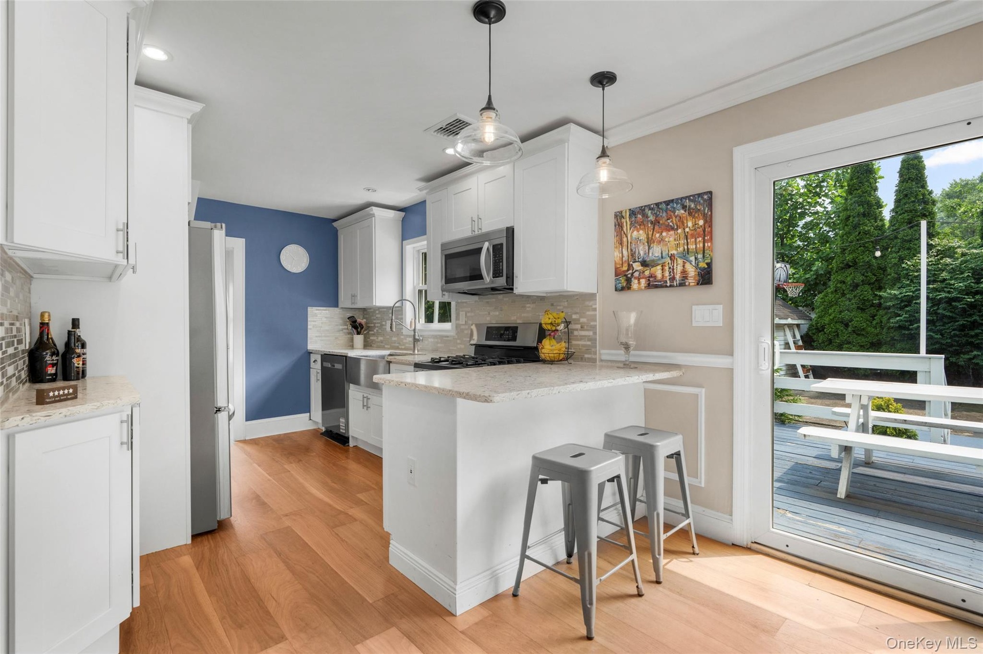 Kitchen featuring white shaker cabinetry and stainless steel appliances.