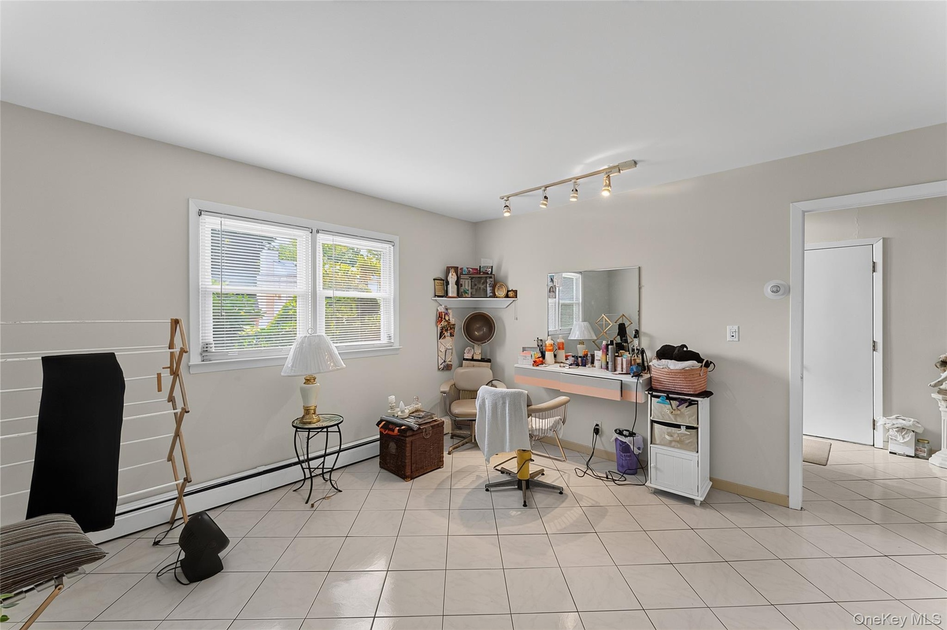 Spacious interior with neutral wall tones and light-toned square tile flooring